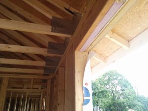 Rigid foam is sandwiched between lumber to form insulated headers over windows. 