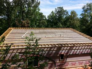 On top of the ice-and-water shield, the builder installed horizontal beams that were raised 6 inches off the deck to allow room for spray foam insulation. 