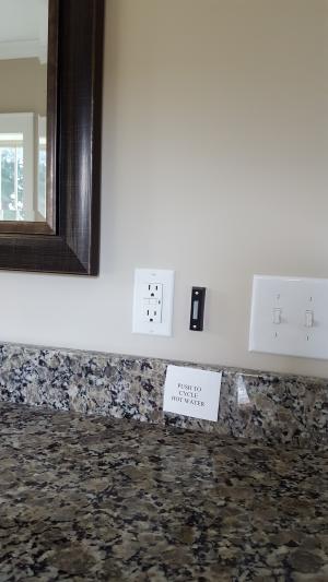 A push button operates the on-demand hot water circulation pump in this master bathroom.