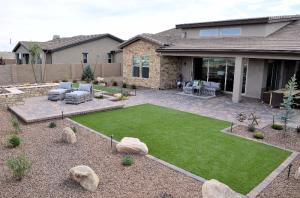 This xeriscaped yard has pavers, rock, and artificial turf.