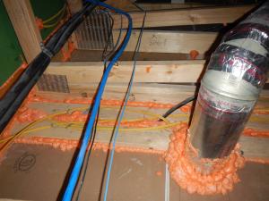 Spray foam air seals gaps around holes and drywall-to-top plate seams.
