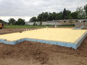 Rigid foam wraps the exterior of the foundation slab.