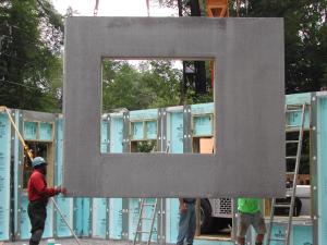 The home’s first-floor walls are constructed of insulated precast concrete panels that are set in place on a gravel bed. 