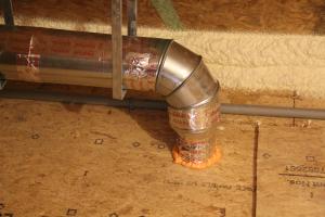 A rigid metal duct vents the exhaust fan. 