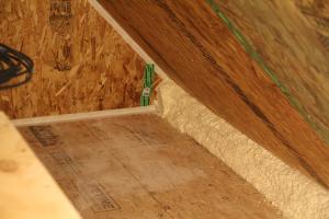 Right - Spray foam insulates the attic eave between the attic floor and the SIP roof panel.