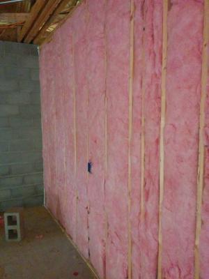 Unfaced batt insulation completely fills the wall cavities.