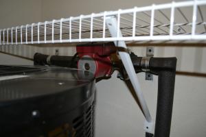 The hot water recirculation pump is hidden behind the water heater in a closet.
