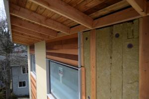 Rigid mineral wool insulation is covered with ¼-inch wood battens which provides a air and drainage gap under the cedar and fiber cement siding.