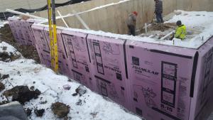 Right - The basement walls are wrapped with 3 inches of XPS rigid foam that will be taped at the seams then covered with a dimpled plastic water barrier.