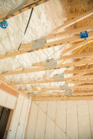 The attic is insulated along the underside of the roof deck with 8 inches of open-cell spray foam.