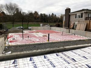 This home is heated with in-floor hydronic radiant heating tubes that were installed on top of the R-20 rigid foam under-slab insulation. 