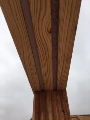 Two layers of rigid foam are sandwiched between three layers of lumber to provide a thermal break in the headers above doors and windows.