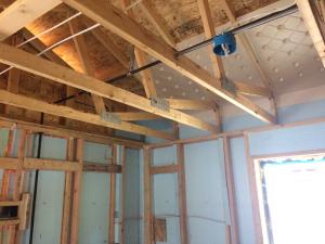 Rigid foam serves as the sheathing on these 2x6 24-inch on center walls; plywood is used only at the corners for wind bracing. 
