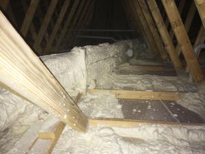 Closed-cell spray foam covers the heat recovery ventilator ducts and also seals all top plates and seams in the ceiling drywall of the vented attic. 