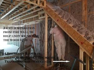 Cellulose insulation is sprayed into wall cavities.