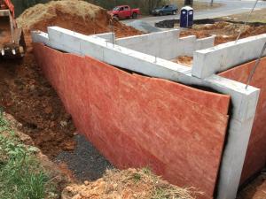 These below-grade walls are insulated along the exterior with R-5 of bug-resistant high-density rigid fiberglass insulation installed over damproofing. 