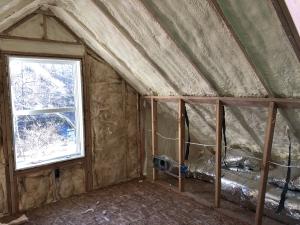 The unvented attic is insulated along the underside of the roof deck with 7 inches (R-49) of closed-cell spray foam, providing vaulted ceilings and a conditioned knee wall space for ducting.  