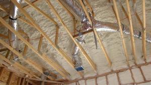 Right – R-25 of open-cell spray foam lines this new home’s attic ceiling, to protect HVAC ducts from heat and cold. 