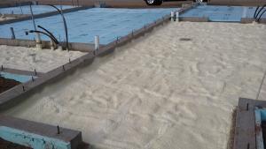Spray foam and rigid foam were used under the slab while rigid foam wraps the exterior of the foundation walls.