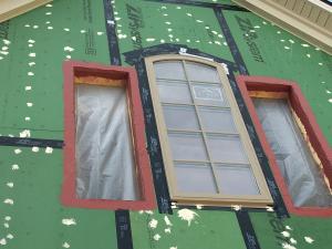 The rough openings for the windows are flashed with a paint-on flashing product then the windows are installed and additional flashing tape is installed over the flashing. Nail holes are sealed with caulk.