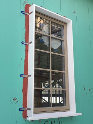 Framing is built around the window before exterior rigid foam is installed on the exterior walls around the window.