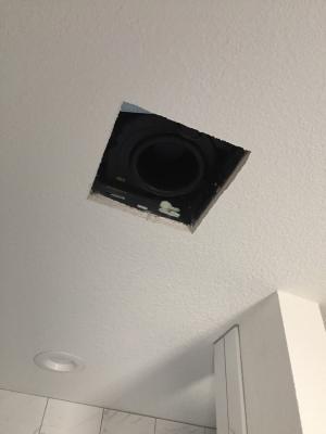 Cut a neat hole in the ceiling with smooth edges in which the exhaust fan housing will fit snugly