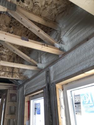 Right - Spray foam fills the walls and rim joists to air seal and insulate while caulk seals the framing joints.