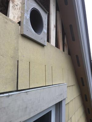 Right – A metal flashing was installed behind the first row of siding above the windows to guide water over the trim.