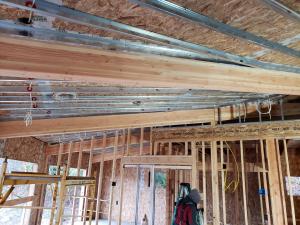 Right – This home’s roof and walls are constructed of SIP panels; metal studs provide fastening surfaces across the long expanses of ceiling in the open interiors.