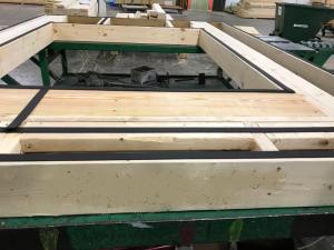 Right – Foam gasket is installed on the surface of the framing before plywood sheathing is installed on these factory-constructed wall panels.