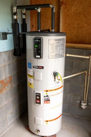 Right – The pipes on this heat pump water heater are carefully insulated.