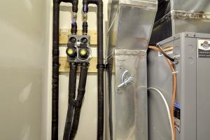 Right – Adequate space is provided near the air handler for the water lines of this ground-source heat pump. 