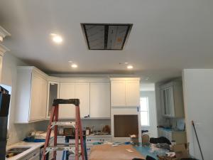 Right – To minimize sound in the kitchen, the exhaust fan above the island-mounted stove top is located above the ceiling rather than just above the stovetop.