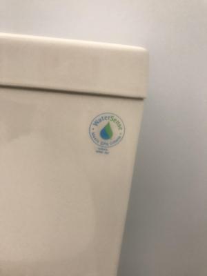Right- The WaterSense label shows this toilet uses less water.