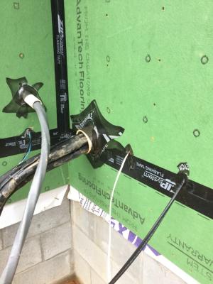 Right – A flexible tape is used to air-seal around wiring holes in the coated sheathing.
