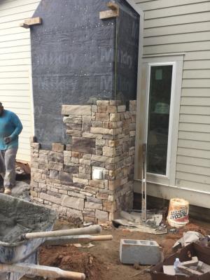 Right – A rigid corrugated rain screen product is installed shingle-fashion with overlapping edges behind rock veneer.