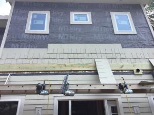 Right – A rigid rain screen product completely covers the wall behind the cladding and window framing.