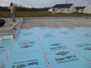 Right – After installing the insulated concrete foundation wall panels, the builder installed underslab rigid foam, which was topped by 4 inches of crushed rock then the poured slab.
