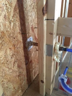 Right – Tape and spray foam are used to air seal around pipes that extend through exterior walls.