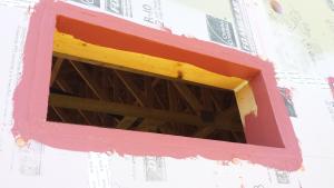 Right – The framing around the window is thoroughly flashed with liquid flashing.