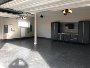 Right – The PV system inverters and battery take up minimal space in the garage.