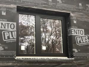 Right - A smart vapor barrier wraps the walls and window frames of this home. Seams are taped to provide an air- and water-resistant barrier. 