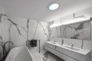 The solar tube installed in the ceiling of this bathroom brings natural light into an interior room that doesn’t have window access.