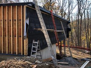 Larsen trusses made of 9-inch I joists, set perpendicular to the exterior wall at 16 inches on center, provide a second wall cavity that can be filled with blown insulation, greatly increasing the insulation value in the walls. 