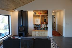 Right - The high-efficiency wood stove is located on an interior wall in this home to provide a secondary heating source in cold climates.