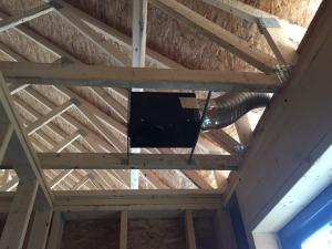 Right – This exhaust fan use metal ducting that goes directly to the soffit to minimize penetrations through the roof. 