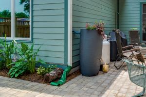 Right – A rain barrel is connected to the downspout of this home while a roll-up run-out on the downspout carries excess water several feet from the home during heavy rainfalls.