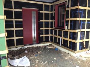 Right – Vertical and horizontal furring strips are installed over a breathable membrane weather resistant barrier to create an air gap and drainage plane behind the wood siding that will be installed next. 