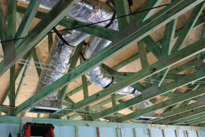 Right – Flex ducts are properly supported with straps that don’t pinch the insulation; closed-cell spray foam will be applied to the underside of the roof deck of this hot-humid climate home to provide an insulated attic space for the HVAC ducts.
