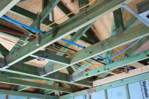 Right – PEX piping speeds hot water directly from the water heater to faucets through the attic in this slab-on-grade home.